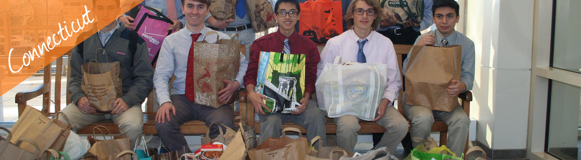 Connecticut Car Donation Banner | Teenage Students holding Care Packages for the Needy